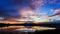 Colorful sky during sunset over the lake, cloud bursting with reflection