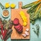 Colorful sliced beetroot on cutting board. Red and yellow beetroot with chard leaves and ingredients on kitchen table backgroun