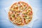 Colorful sliced pizza with mozzarella cheese, chicken, sweet corn, sweet pepper and parsley close up top view