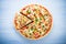 Colorful sliced pizza with mozzarella cheese, chicken, sweet corn, sweet pepper and parsley top view