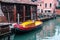 Colorful small boats for transport in a canal of Venice