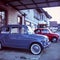 Colorful small classic cars parked in a small village in Switzerland, shot with analogue slide film technique