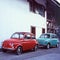 Colorful small classic cars parked in a small village in Switzerland, shot with analogue slide film technique