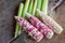 Colorful small ears waxy corns with silk, corn leaf and old wooden background