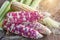 Colorful small ears waxy corns with silk, corn leaf and old wooden background