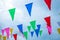 Colorful small flags with cloudy sky background.