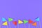 Colorful small paper flags at bottom on purple background