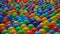 Colorful small plastic balls floating and moving in water, closeup view.