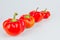 Colorful small red peppers on a white background. Sweet pepper Mini Bell. Assorted paprika. Peppers in a row. From