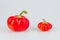 Colorful small red peppers on a white background. Sweet pepper Mini Bell. Assorted paprika. Peppers in a row. From