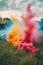 colorful smoke bombs in a grassy field