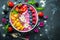 A colorful smoothie bowl with artistic fruit arrangements.