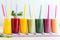 colorful smoothie collection in tall glasses with straws