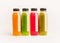 Colorful smoothie or juice bottles stand on white background, front view.