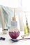 Colorful smoothie in a small bottle in form of light bulb with drinking ecofriendly straw and fresh blueberries