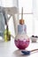 Colorful smoothie in a small bottle in form of light bulb with drinking ecofriendly straw and fresh blueberries