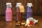 Colorful Smoothies at the bottles. Colorful drink, milk shake in bottle with fresh vegetables and superfoods on a wooden