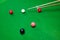 Colorful snooker balls on the green snooker table with cue