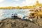 A Colorful snorkle or diving mask located on the rocks with snorkling group on the back