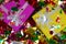 Colorful sparkling birthday or other concept presents in purple and yellow box with confetti top view background