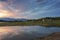 Colorful, spectacular sunset over Balkan mountain, artificial lake Jrebchevo and abandoned, ruined church. Last rays of light.