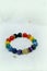 Colorful spectrum lucky stone bracelet bead on white towel background.fashion with believe in Add charm,property, healthy