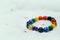 Colorful spectrum lucky stone bracelet bead on white towel background.fashion with believe in Add charm,property, healthy