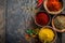 Colorful Spices in Wooden Bowls on Rustic Background