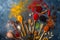 Colorful spices in wooden spoons, seeds, herbs and nuts on dark stone table.