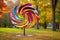 colorful spinning wind sculpture in a park