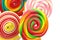 Colorful spiral lollipops on white background, close up.