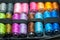 Colorful spools of sewing threads stack