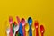 Colorful spoons on a yellow background.