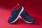 Colorful sport footwear or shoes on red color backround. Running fashion sneaker for fitness and training.