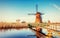 Colorful spring day with traditional Dutch windmills canal in Ro