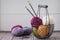 Colorful spring wool yarn in an iron basket with wooden knitting needles