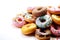 Colorful Sprinkled Donuts, White Background. Generative AI