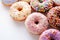 Colorful Sprinkled Donuts, White Background. Generative AI