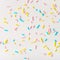 colorful sprinkles on white background