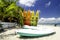 Colorful stacked kayaks on the tropical beach with cloudy blue s