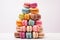 Colorful stacked macarons on a white background.