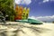 Colorful stacking kayaks on white sandy beach at sunny day. blue sky and clear sea water background