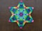 A colorful Star Of David on a wooden background