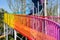 Colorful steel footbridge spiraling up in blue sky at winter noon