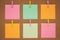 Colorful stickers on the clothespin on cork board, wood background. Concept of planning. Note for writing. Sticky notes, blank pap