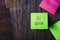Colorful sticky notes on wooden background board reminder with copyspace. Go green written sticker on pineboard. Save the nature