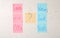 Colorful sticky notes with written baby names on white wooden background, flat lay
