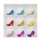 Colorful stiletto high heel shoes exhibited on white shelf, isolated on white background