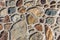 Colorful stony wall, multiple stones linked with cement, stone texture