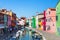 Colorful street of Burano island, canal in Venice